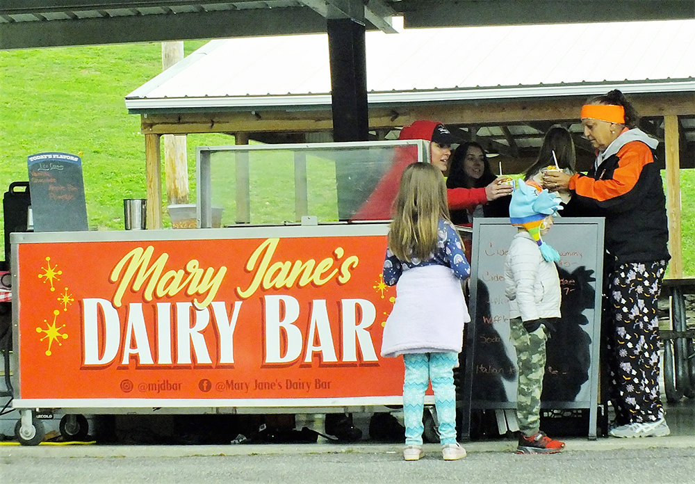 Mary Gallo (L), owner of Mary Jane’s Dairy Bar, hands JoAnn Reed a very sweet treat